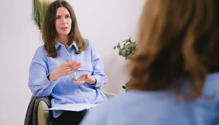 Consultation between practitioner and patient, illustrating the importance of communication and trust in aesthetic practice marketing strategies.