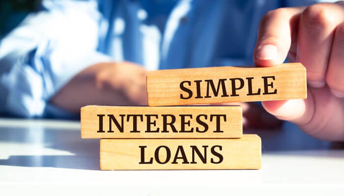 Wooden blocks stacked with the words simple interest loan written on them, symbolizing straightforward borrowing and repayment terms