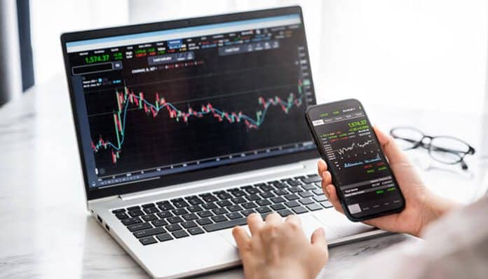 Funded traders strategies shown on laptop and mobile screens with live trading charts, highlighting risk management and profit tracking tools.