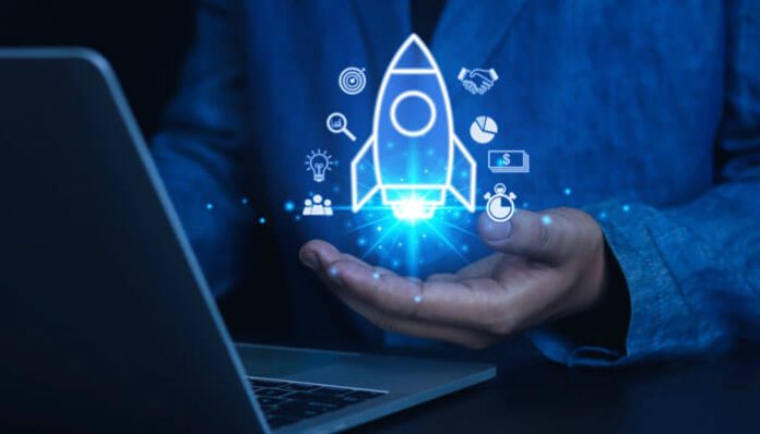 Business professional holding a glowing rocket startup icon with digital technology graphics, symbolizing innovative digital strategies for startups