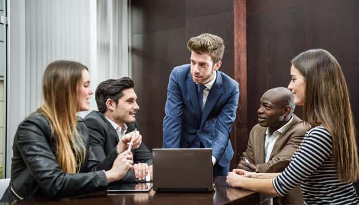Team of professionals discussing strategies and collaborating on selecting a recruitment agency to meet their hiring needs.