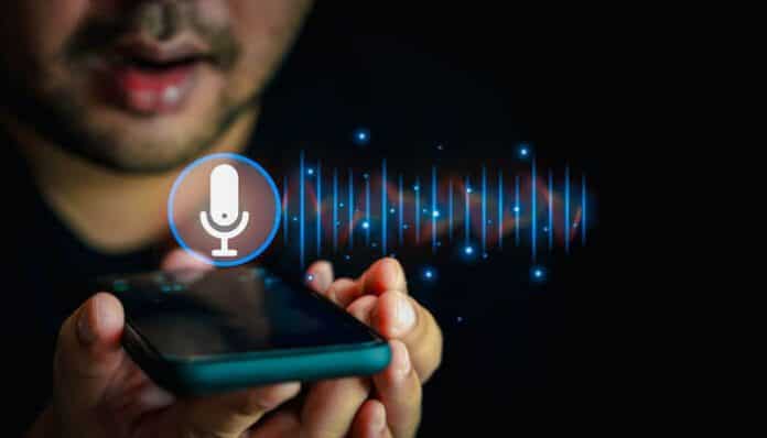 AI voice assistant technology in action with a person using voice commands on a smartphone, symbolizing AI voice generation and communication