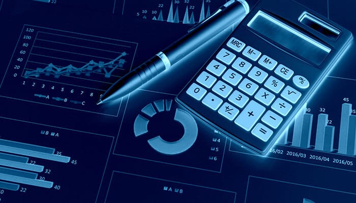 A close-up of a calculator, pen, and financial charts displaying graphs and data analysis. This image emphasizes the importance of understanding and managing startup finances through effective budgeting and financial analysis.