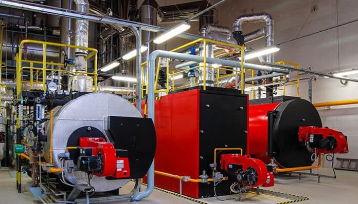 Modern industrial boiler supplies and equipment in a factory setting, showcasing high-quality boilers and supporting infrastructure.