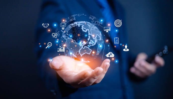 Business professional holding a digital globe with icons representing technology, innovation, and sustainability, symbolizing emerging global business trends.