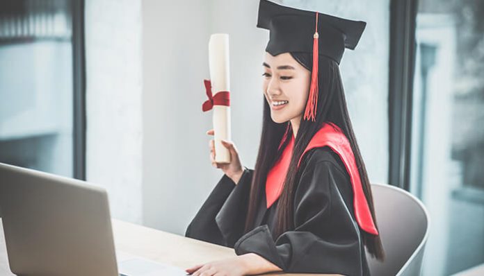 Smiling graduate holding certificate during virtual ceremony, representing secure diploma online verification.