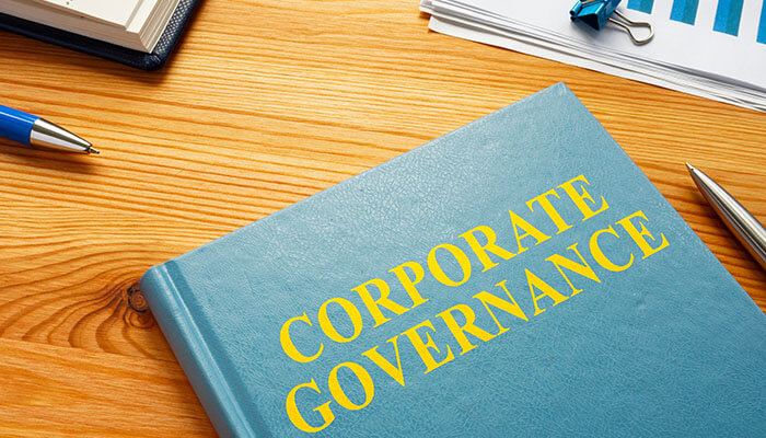 A business professional holding a digital globe surrounded by icons, symbolizing the emerging global business trends shaping industries and markets worldwide.