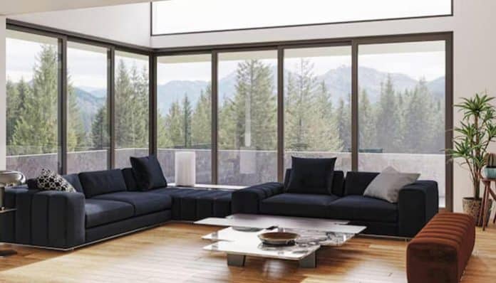 Modern living room with panoramic aluminium windows in Scotland offering scenic mountain views and natural light.