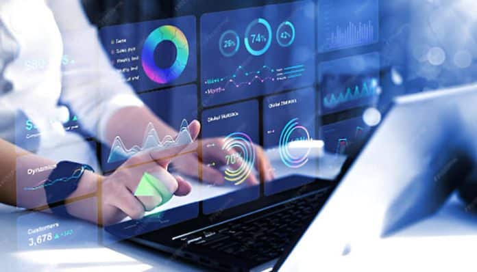 Person using laptop with digital analytics dashboard and futuristic data charts, representing modern creative business technology and innovation