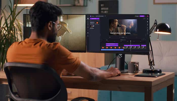 A person editing Lyric Videos on a computer using professional video software, showing synchronized lyrics on screen for creative branded content production.