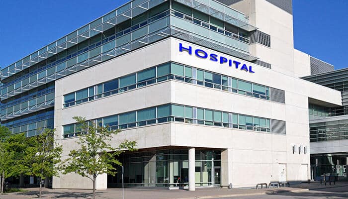 Modern hospital building representing healthcare costs and highlighting common health insurance myths about coverage and hospitalisation claims.