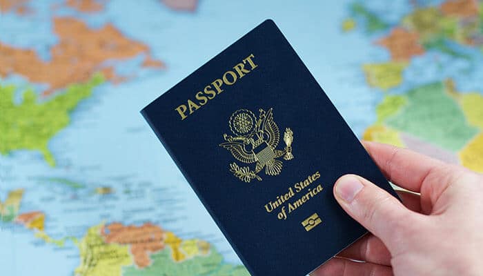 Global mobility visa concept with a U.S. passport held over a world map, symbolizing international travel, expansion, and business opportunities