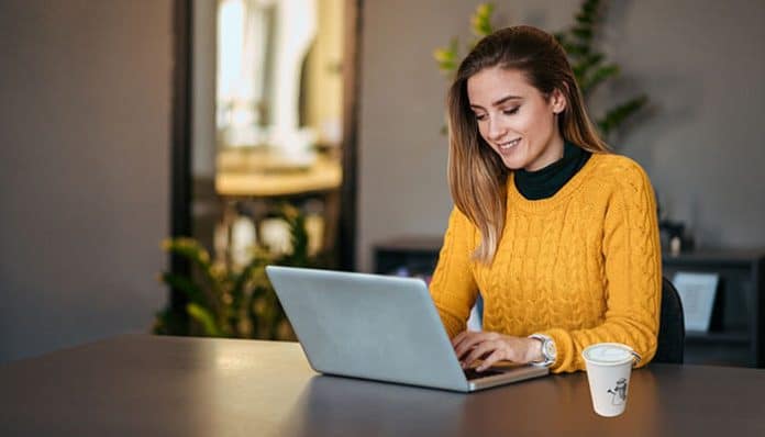 An entrepreneur educating herself as she works on a laptop, showcasing the importance of continuous learning to educate yourself as an entrepreneur.