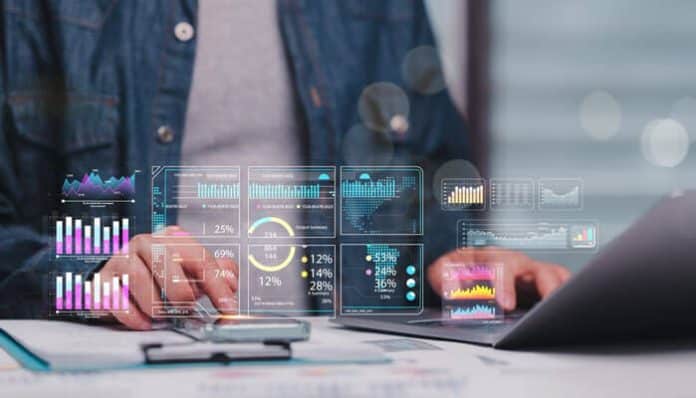 A professional analyzing digital dashboards and KPIs on a laptop, illustrating data-driven performance management with analytics tools.