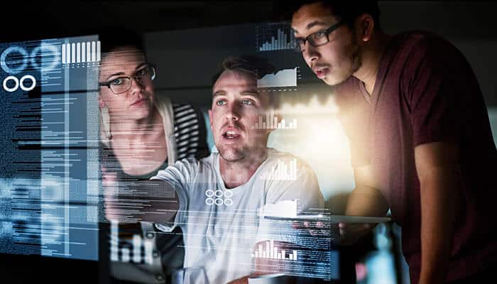 A team of professionals analyzing digital dashboards and data on a large screen, illustrating how a document-to-data platform helps businesses extract and understand complex information.