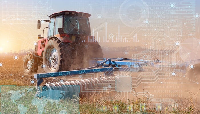 A tractor working in a field with digital data overlays, illustrating how real-time satellite images in agriculture enhance modern farming efficiency and precision.