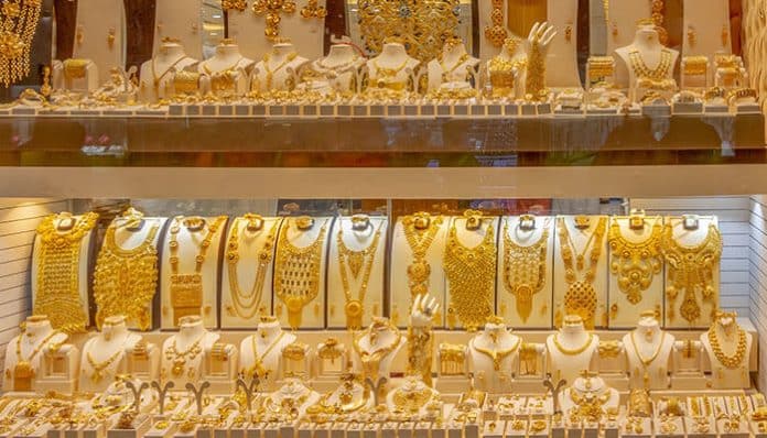 A luxurious display of gold necklaces, bangles, and earrings in a Scottsdale boutique—highlighting the elegance of jewelry investment and resale in Scottsdale’s vibrant market.
