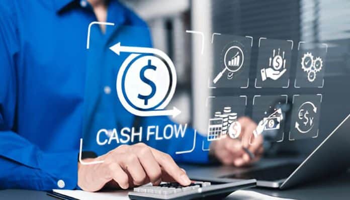 A business professional analyzing financial data on a laptop, representing a Fractional Controller improving cash flow management using smart financial tools