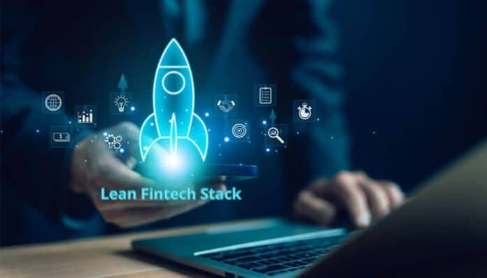 A business professional using a laptop with a digital rocket icon and fintech elements symbolizing a Lean Fintech Stack for startup growth.