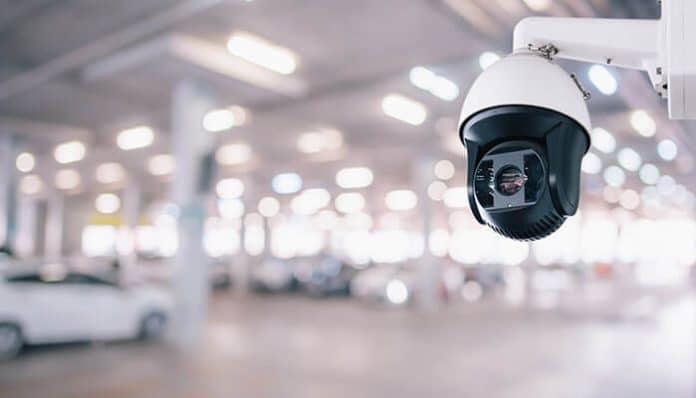 Smart security camera monitoring a parking area highlights the importance of surveillance systems for Dallas businesses.