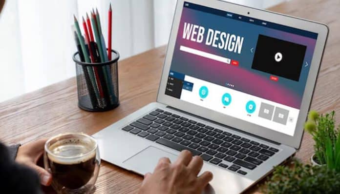 A designer working on a laptop creating a website layout, showcasing the concept of Modern Web Design with responsive interface and creative UI elements.