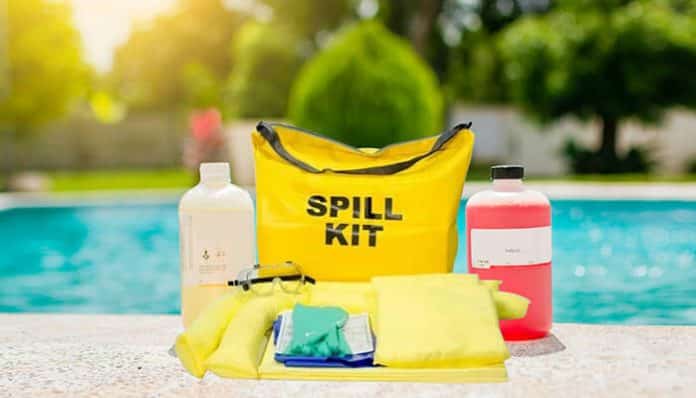 A yellow spill kit with safety supplies placed beside a pool, demonstrating the use of portable spill kits for quick cleanup and chemical safety.