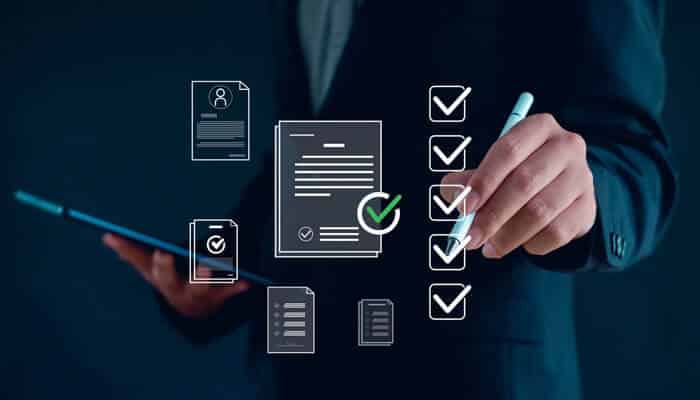 A professional marking completed tasks on a digital Healthcare Compliance Checklist with icons of documents and checkmarks on a virtual screen