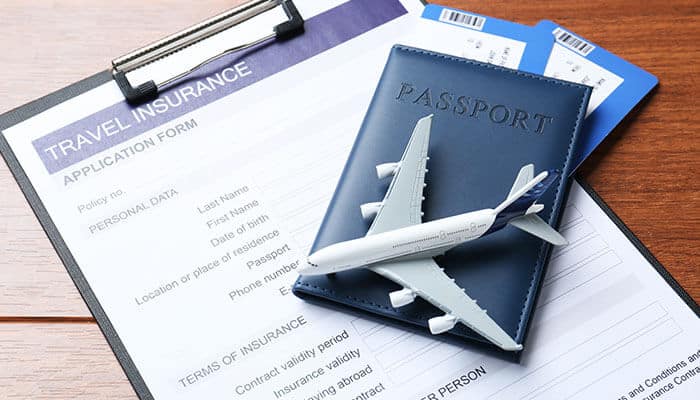 Travel perks with a credit card, featuring a passport, airplane model, travel insurance application form, and travel tickets, highlighting the benefits of using credit cards for travel