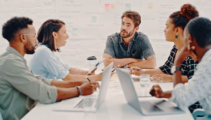 Group of professionals collaborating with local startups during a meeting, discussing strategies for urban development and innovation