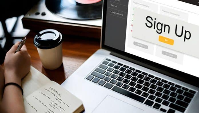 Person signing up on a laptop, illustrating common signup mistakes on popular apps like incorrect data entry or verification issues.