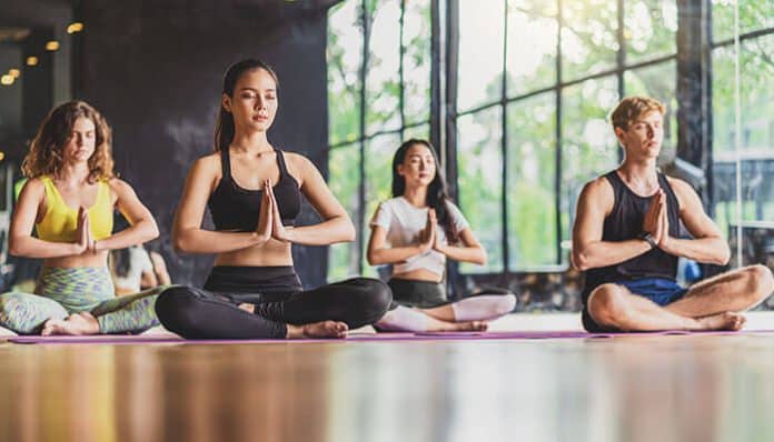 Daily yoga practice session in a studio promoting flexibility, mindfulness, and group wellness
