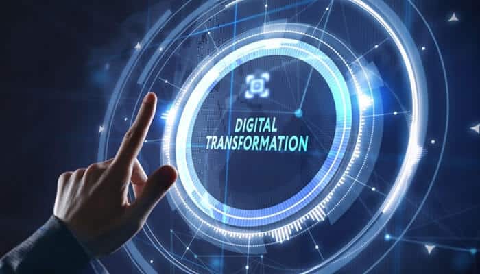 Business leaders embracing digital transformation, symbolized by a hand interacting with a digital interface, highlighting the importance of adapting to technological advancements