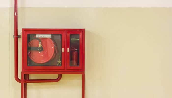 A fire hose cabinet, similar to a riser cupboard, demonstrating proper installation and maintenance that meets safety standards and pass inspection