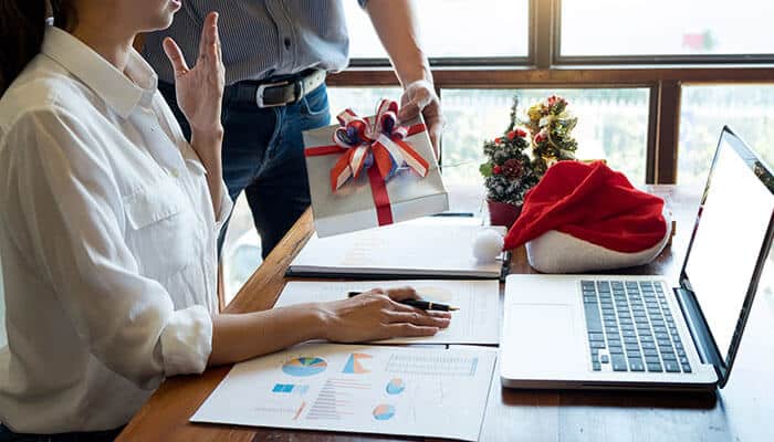 Employee Holiday Engagement Programs featuring gift giving and employee recognition in the workplace