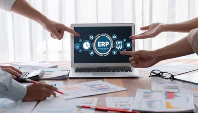 A team discussing ERP software on a laptop, illustrating the features of best ERP software for nonprofits and how it optimizes business processes for nonprofits.