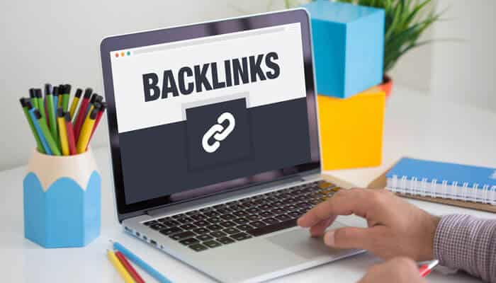 A laptop screen showing the word BACKLINKS, emphasizing the importance of backlink building in SEO for Bootstrapped Startups to improve online visibility and rankings