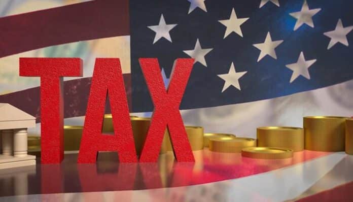 The word 'TAX' in bold red letters with a US flag backdrop, symbolizing tax filing and services like FreeTaxUSA for efficient online tax preparation