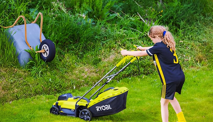 Child using a RYOBI tools-powered lawn mower to maintain the garden, demonstrating the ease and efficiency of RYOBI's outdoor equipment.