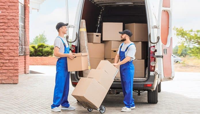 Full-service office movers loading business equipment and boxes into a moving truck