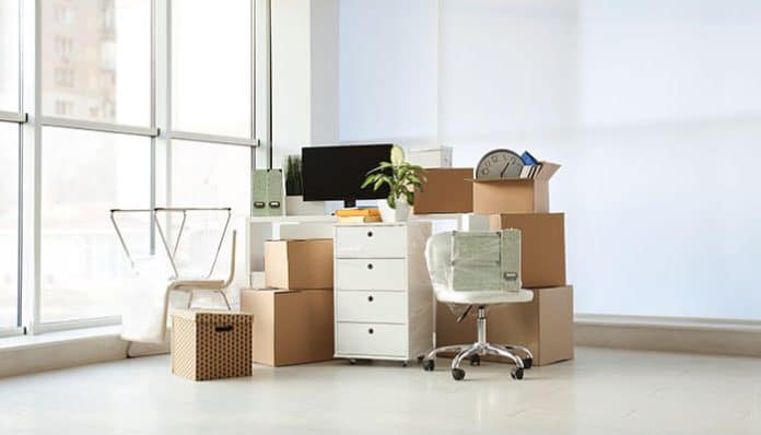 Full-service business moving preparing office furniture and equipment for secure relocation