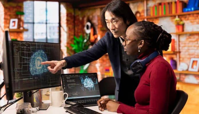 A marketing team analyzing data on a computer to build ideal customer profiles in B2B using advanced machine learning insights.