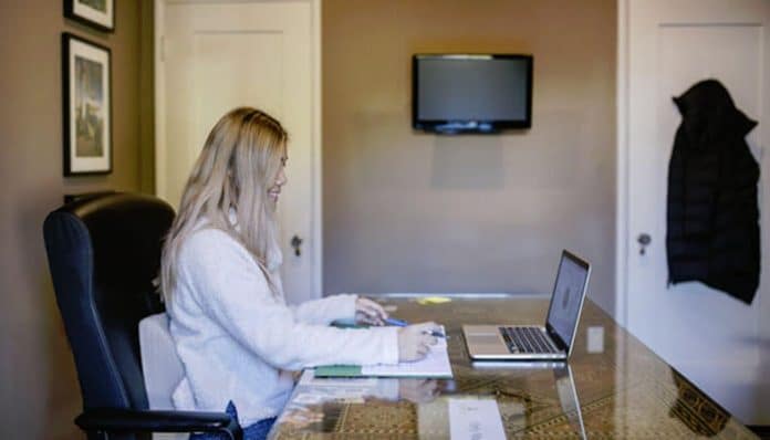 Home Medical Billing Business setup with a professional working from home on a laptop, focusing on business tasks and administrative work