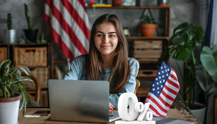 A woman working on her laptop, smiling with a 0% symbol and an American flag in the background, highlighting tax savings with FreeTaxUSA