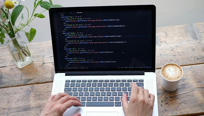 Close-up of a laptop displaying code, representing the type of technical work performed by Node.js developers. Hire Node.js developers to build scalable serverless applications