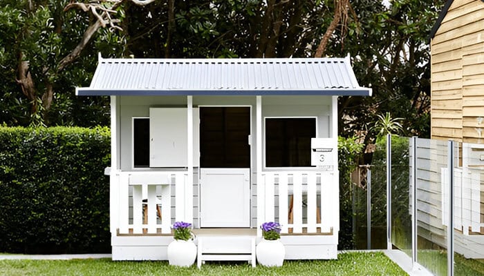 White cubby house for children offering a secure and fun backyard play space