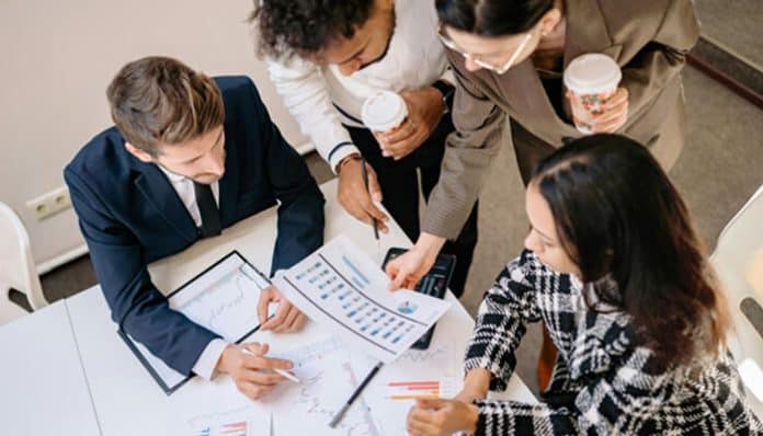 Ambitious entrepreneurs collaborating and discussing business strategies, analyzing documents, and planning their next steps for growth and success