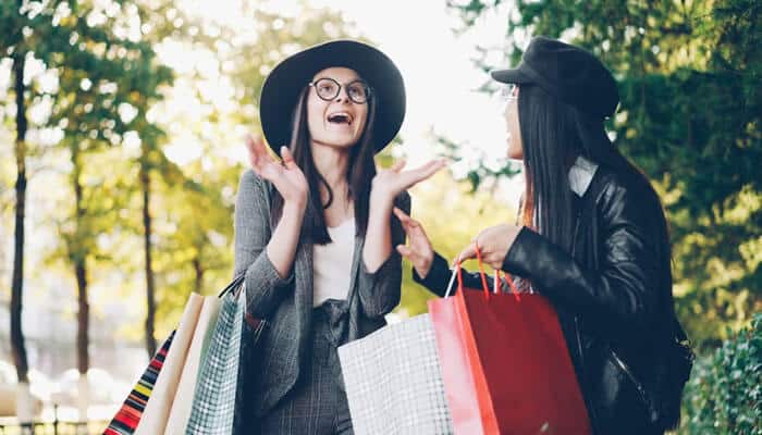 Two women shopping together and enjoying the experience, showcasing how brand trust and loyalty can influence customer relationships and brand advocacy