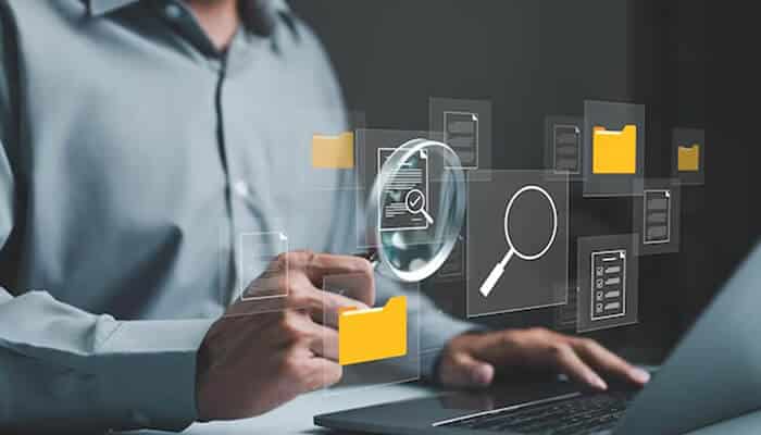 Person using a laptop to perform a Fast People Search, verifying information through digital tools and filters on the screen.