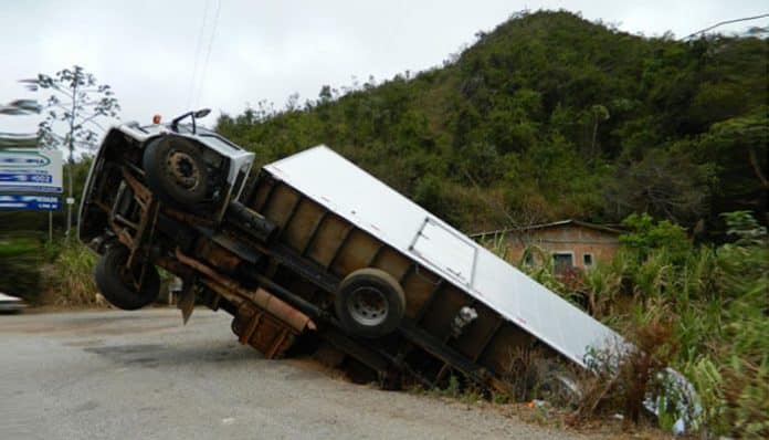 Overturned truck in a ditch, highlighting the importance of black box records in truck accident cases for investigating the cause