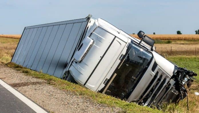 Overturned semi-truck on a rural roadside, illustrating evidence needed for a Settlement in a Truck Accident Claim